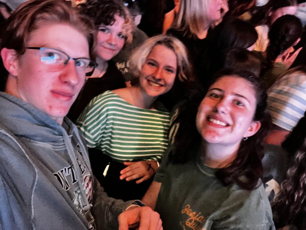 Youth group members smiling together at a concert