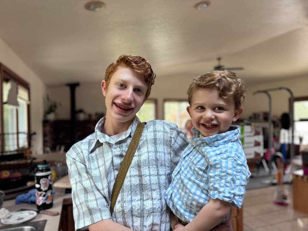 Two smiling boys at a youth gathering